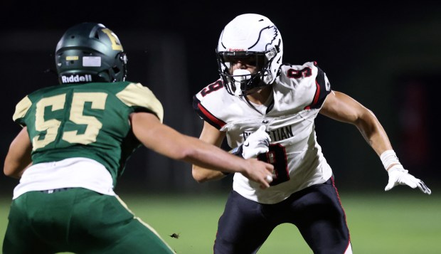 Aurora Christian's Dominic Klimpke (9) battels St. Edward's Luciano Mauro (55) at the line during a Chicagoland Christian Conference game Friday, Sept. 12, 2025 in Elgin. (H. Rick Bamman / The Beacon-News)
