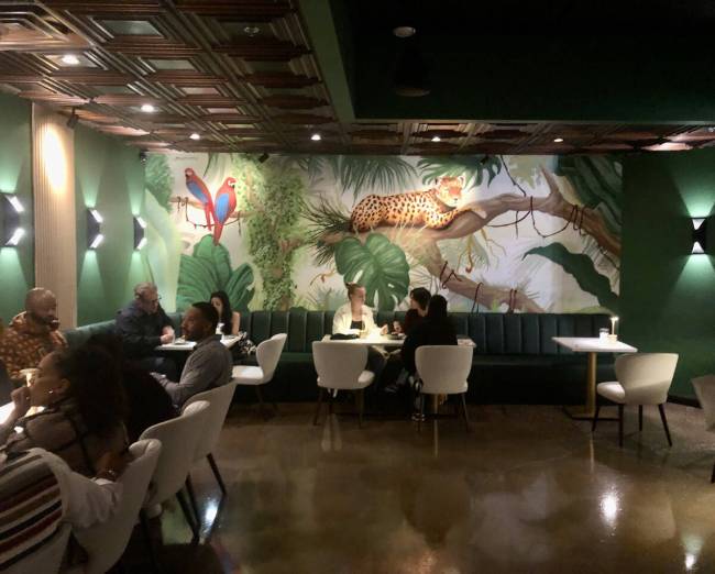 Vibrant murals in the lounge at the stylish art deco-inspired CC Speakeasy give the working ice ...