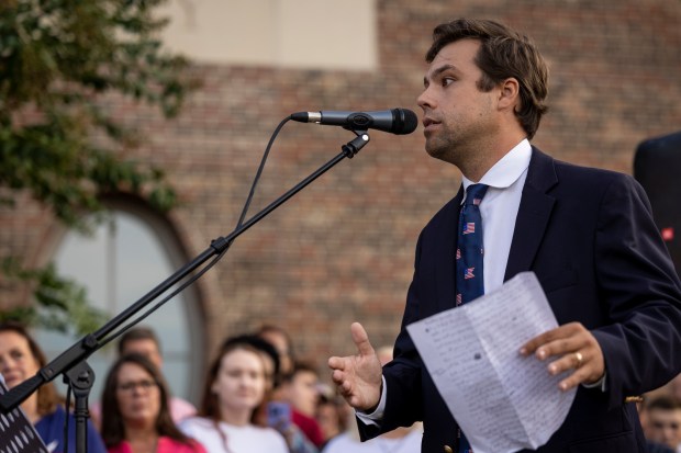 Trevor Topping, who helped organize the event, speaks before a...