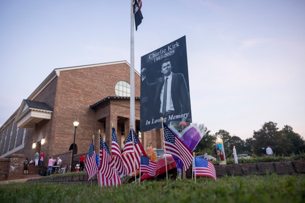 A memorial sign for Charlie Kirk is placed at the...
