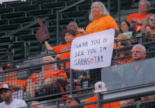 A Baltimore Orioles fans displays a sign that reads, "Thank you O's, see you in Sarasota!" during the final home major league baseball game of the season at Oriole Park at Camden Yards. (Karl Merton Ferron/Staff)
