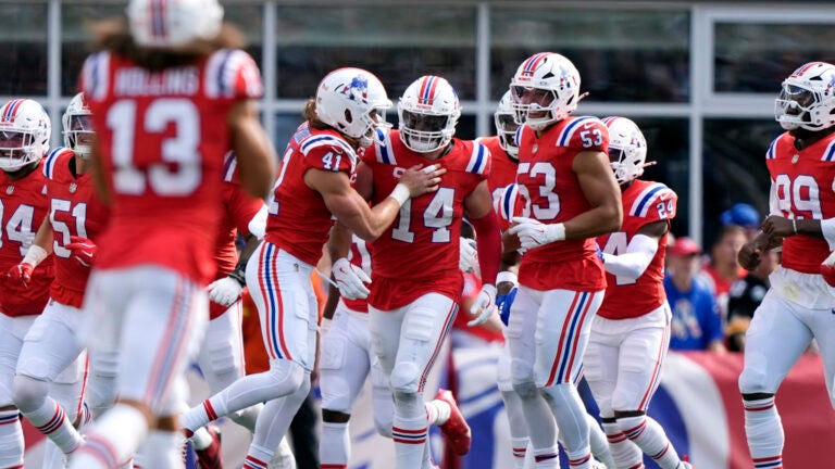 New England Patriots linebacker Robert Spillane (14) celebrates with teammates after an interception against the Pittsburgh Steelers during the second half of an NFL football game, Sunday, Sept. 21, 2025, in Foxborough, Mass.