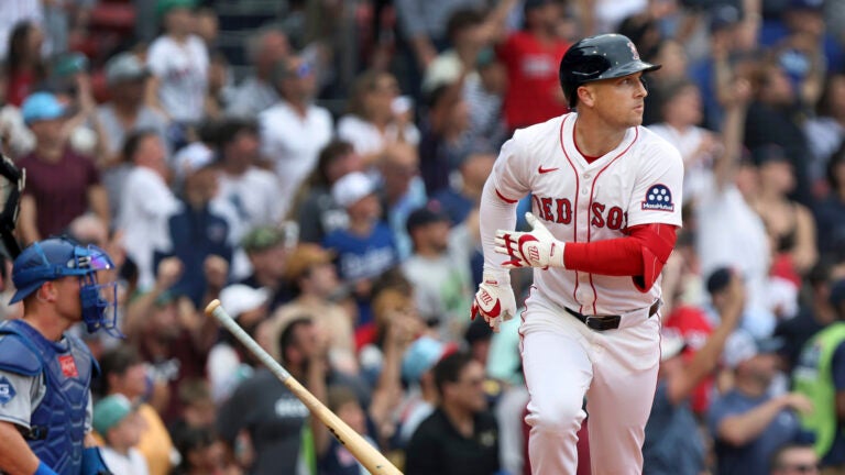 Boston Red Sox batter Alex Bregman, right, tosses his bat aside as he watches the flight of his fifth-inning two-run home run during a baseball game against the Los Angeles Dodgers, Sunday, July 27, 2025, in Boston.