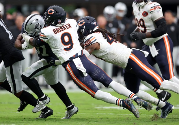 Bears safety Jaquan Brisker (9) tries to tackle Raiders running back Raheem Mostert in the third quarter Sept. 28, 2025, in Las Vegas. (Chris Sweda/Chicago Tribune)