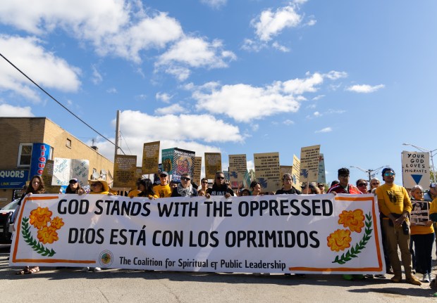 Members of the procession march while praying and worshiping during...
