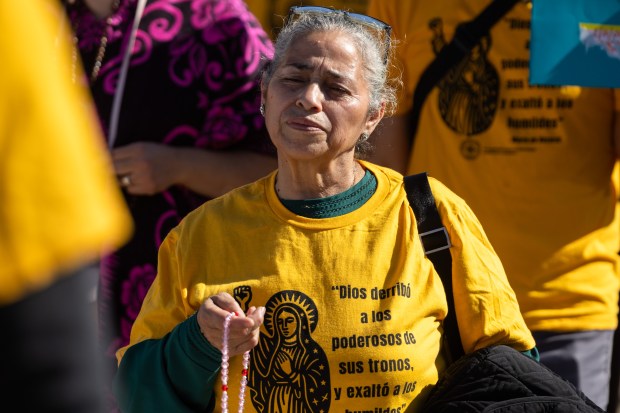 Angela Cervantes of Chicago prays the rosary during the Coalition...