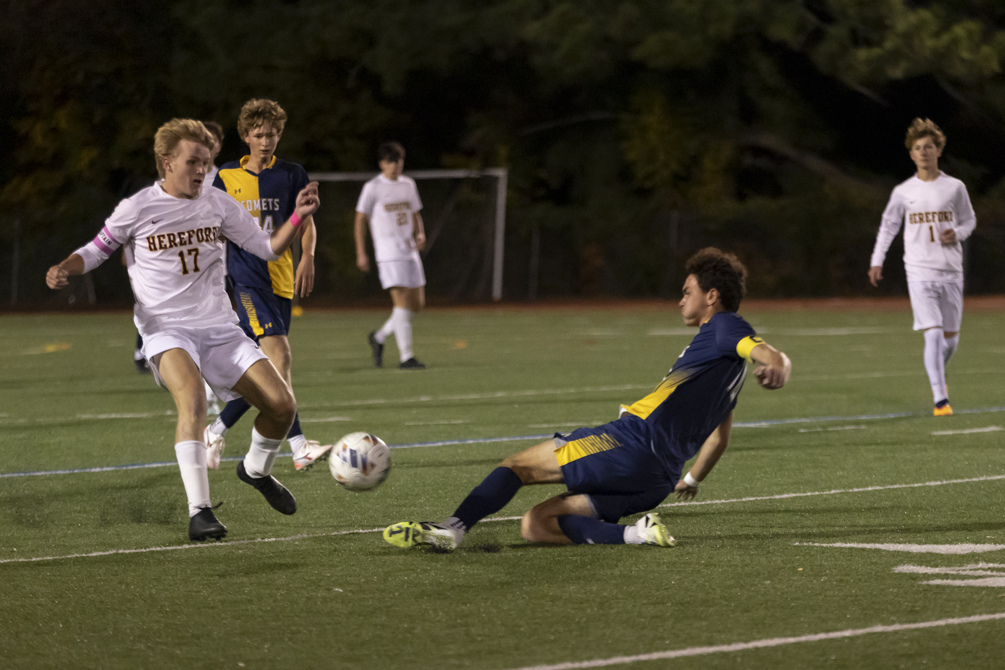 Catonsville’s Toby Tracht slide tackles the ball away from Sam...