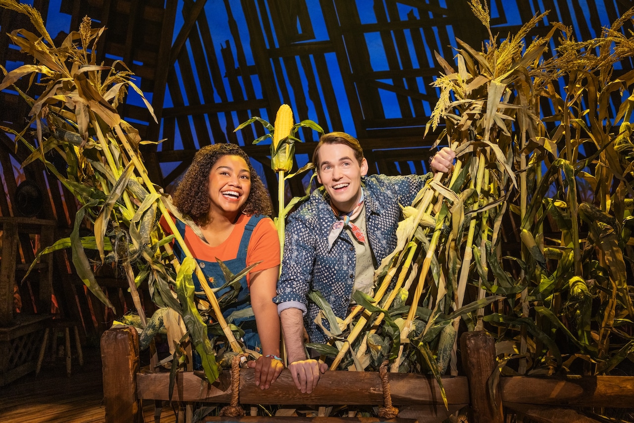 Maya Lagerstam and Tyler Joseph appear in costume on stage surrounded by cornstalks