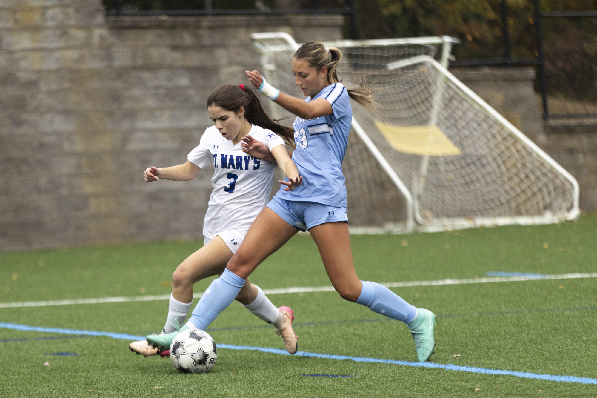 Saint Mary’s Addison Sides and Allie Lindner fight for possession...