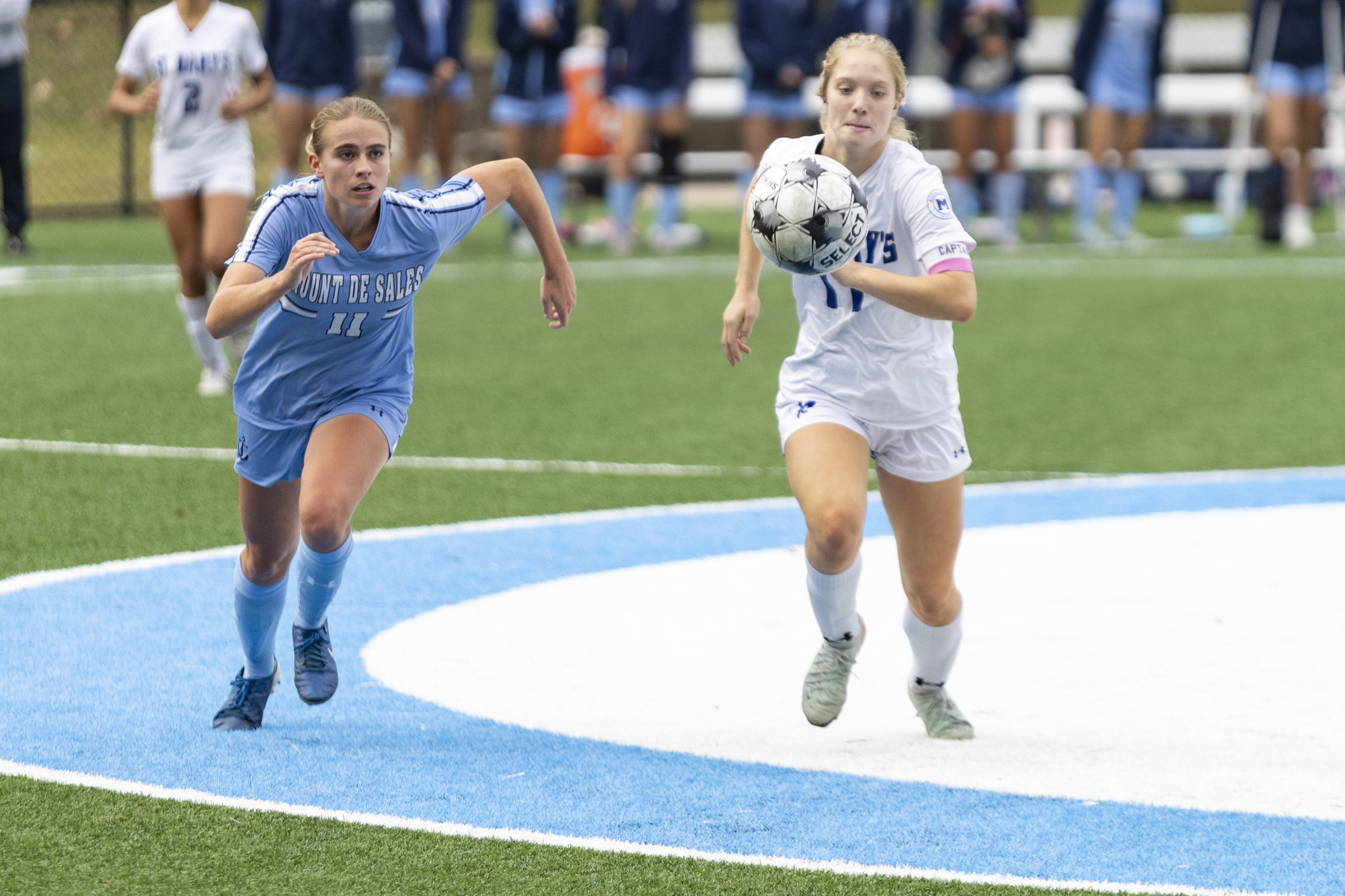 Ella Powers, left, and Elizabeth Schummer run down a loose...