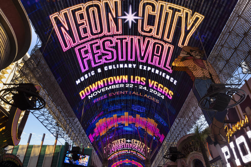 Information for the Neon City Festival is displayed on the Fremont Street Experience canopy
 ...
