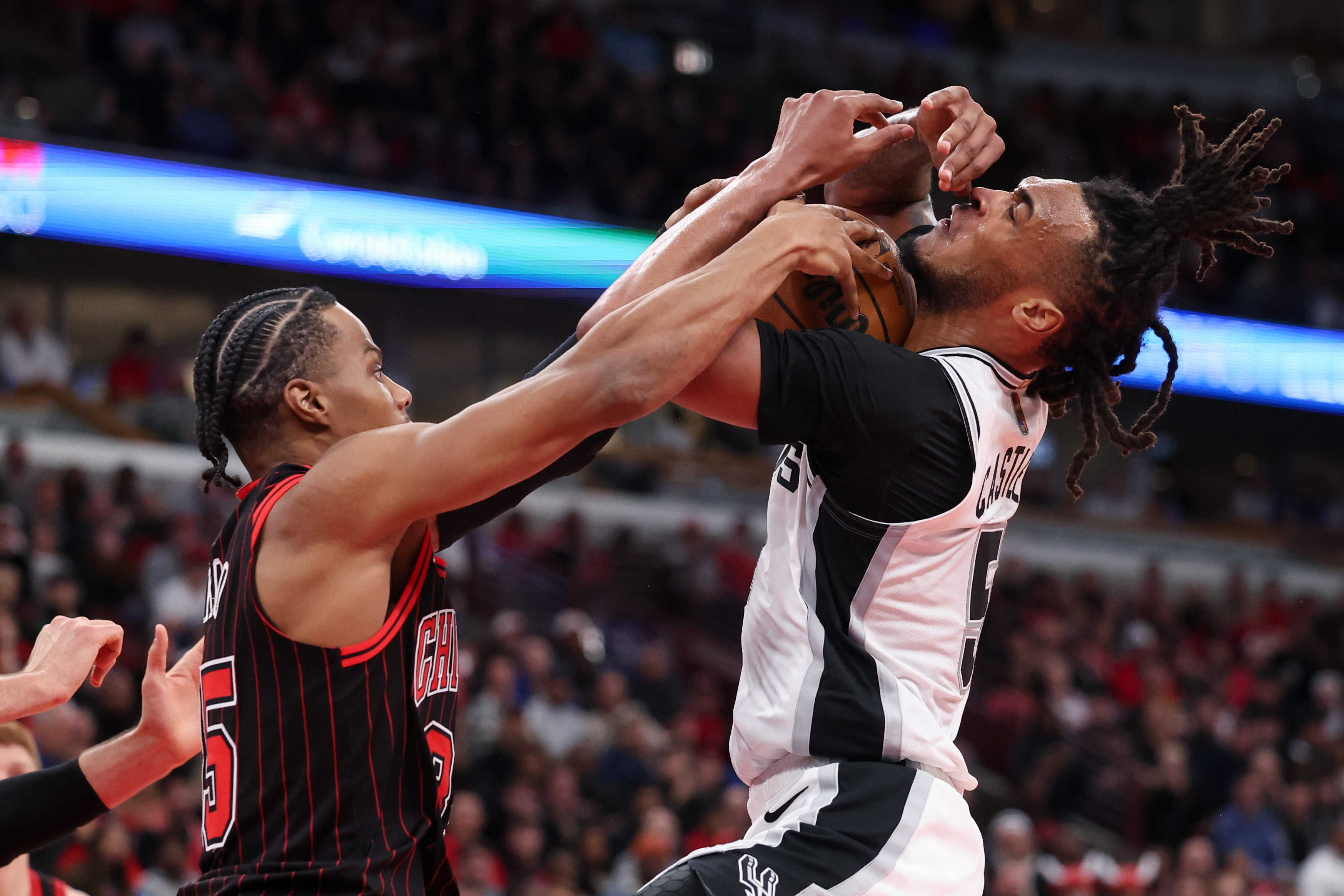 Chicago Bulls forward Isaac Okoro (35) guards San Antonio Spurs guard Stephon Castle (5) during the fourth quarter at the United Center on Monday, Nov. 10, 2025, in Chicago. (Armando L. Sanchez/Chicago Tribune)