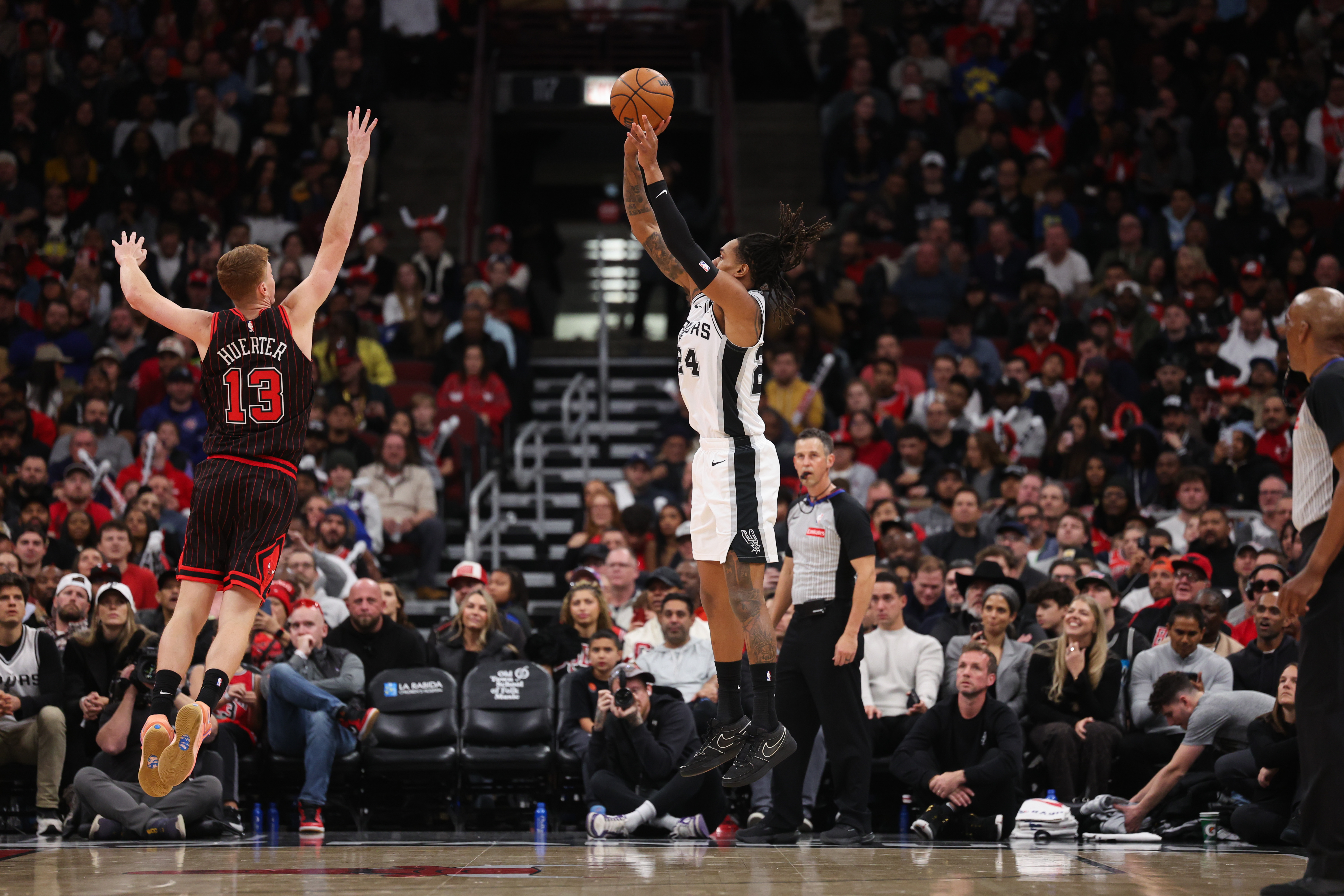 San Antonio Spurs guard Devin Vassell (24) shoots a 3-point basket over Chicago Bulls guard Kevin Huerter (13) during the second quarter at the United Center on Monday, Nov. 10, 2025, in Chicago. (Armando L. Sanchez/Chicago Tribune)