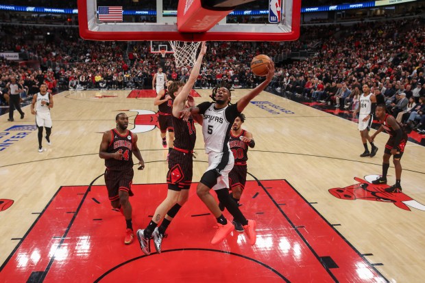 Chicago Bulls forward Matas Buzelis (14) guards San Antonio Spurs guard Stephon Castle (5) while he goes up for a shot during the first half at the United Center on Monday, Nov. 10, 2025, in Chicago. (Armando L. Sanchez/Chicago Tribune)