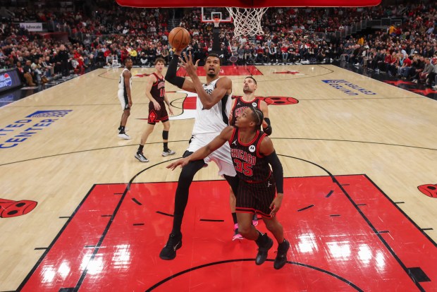San Antonio Spurs forward Victor Wembanyama (1) goes up for a shot over Chicago Bulls forward Isaac Okoro (35) during the first half at the United Center on Monday, Nov. 10, 2025, in Chicago. (Armando L. Sanchez/Chicago Tribune)