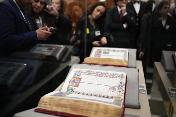 Reporters look at the 15th century Borso D’Este Bible, comprising...