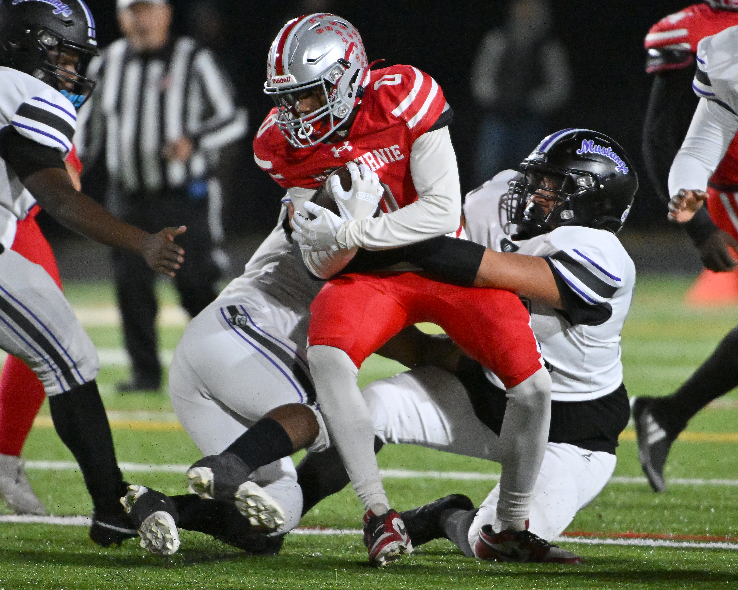 Nov. 14, 2025: Glen Burnie's Chris Maddox ​intercepts a Meade pass and is tacked by Jayden Rumley and Kristopher Marin in the second quarter. The Glen Burnie Gophers defeat the visiting Meade Mustangs, 41-35, in a MPSSAA Class 4A East Region second round playoff football game. (Paul W. Gillespie/Staff)
