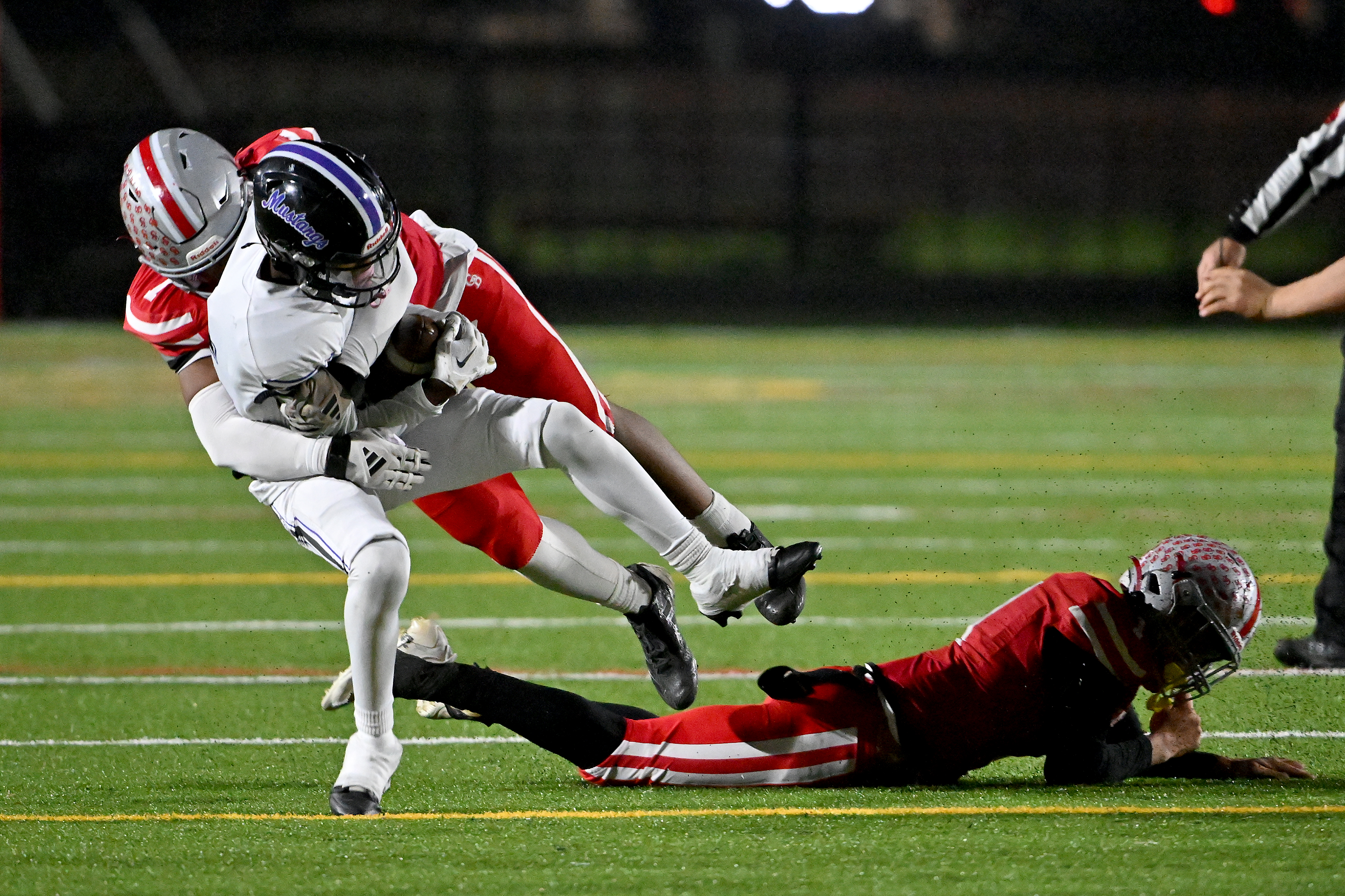 Nov. 14, 2025: Glen Burnie's Jean Mitchell ​tackles Jayden Rumley holding him to no gain on a catch in the second quarter. The Glen Burnie Gophers defeat the visiting Meade Mustangs, 41-35, in a MPSSAA Class 4A East Region second round playoff football game. (Paul W. Gillespie/Staff)
