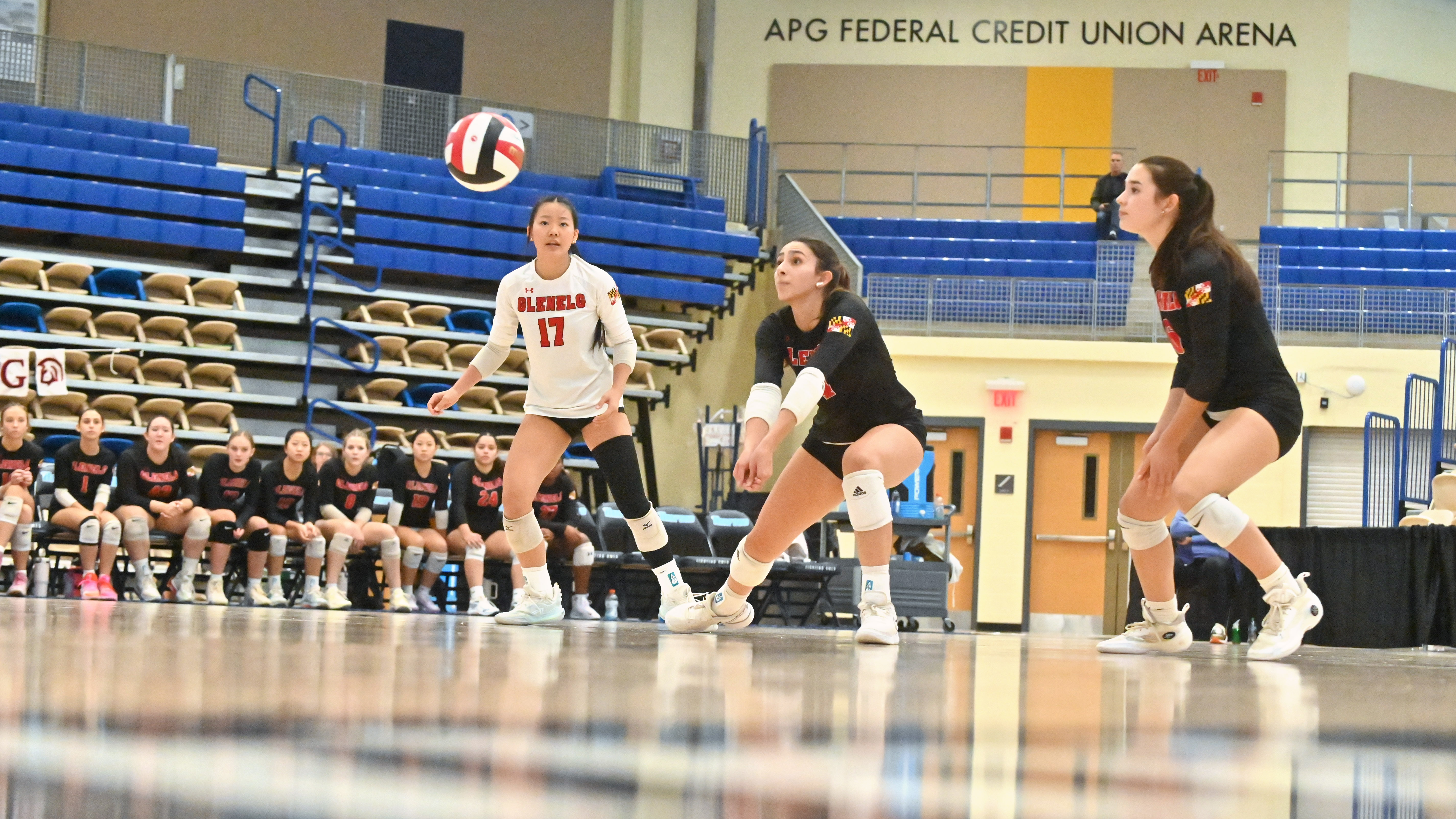 Glenelg's Isard Bernades digs a Williamsport serve between teammates Bella Chen, left, and Lainey White during the Class 2A volleyball state championship at Harford Community College on Saturday. (Brian Krista/Staff)