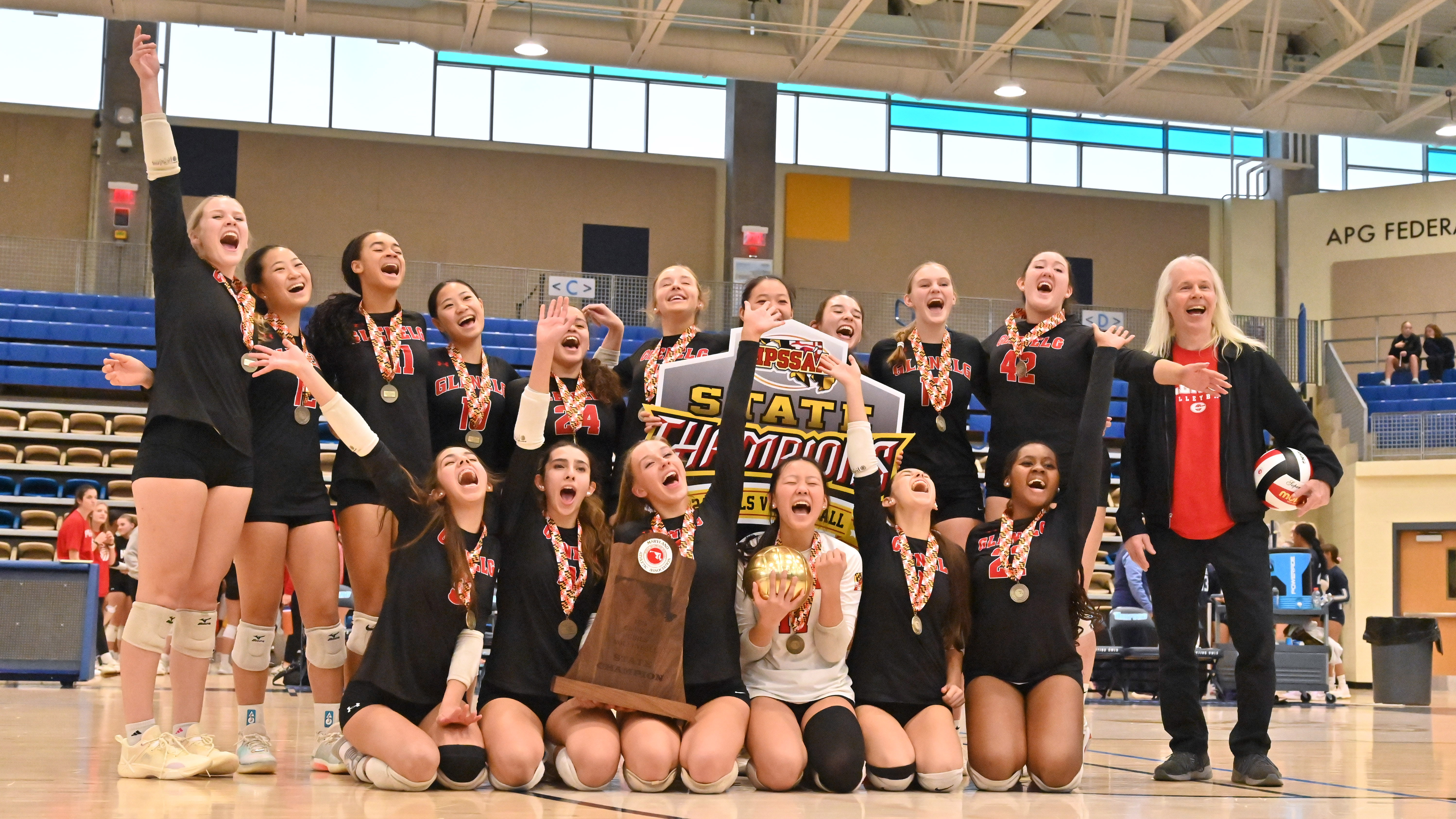 Glenelg's volleyball team celebrates with their trophy following their win over Williamsport during the Class 2A volleyball state championship at Harford Community College on Saturday. (Brian Krista/Staff)