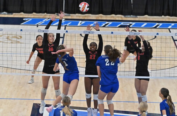 Glenelg teammates, from left, Avery Hubbard, Tise Tokunboh-Salako and Lainey White get in position to block a hit by Williamsport's Skylar Norris during the Class 2A volleyball state championship at Harford Community College on Saturday. (Brian Krista/Staff)