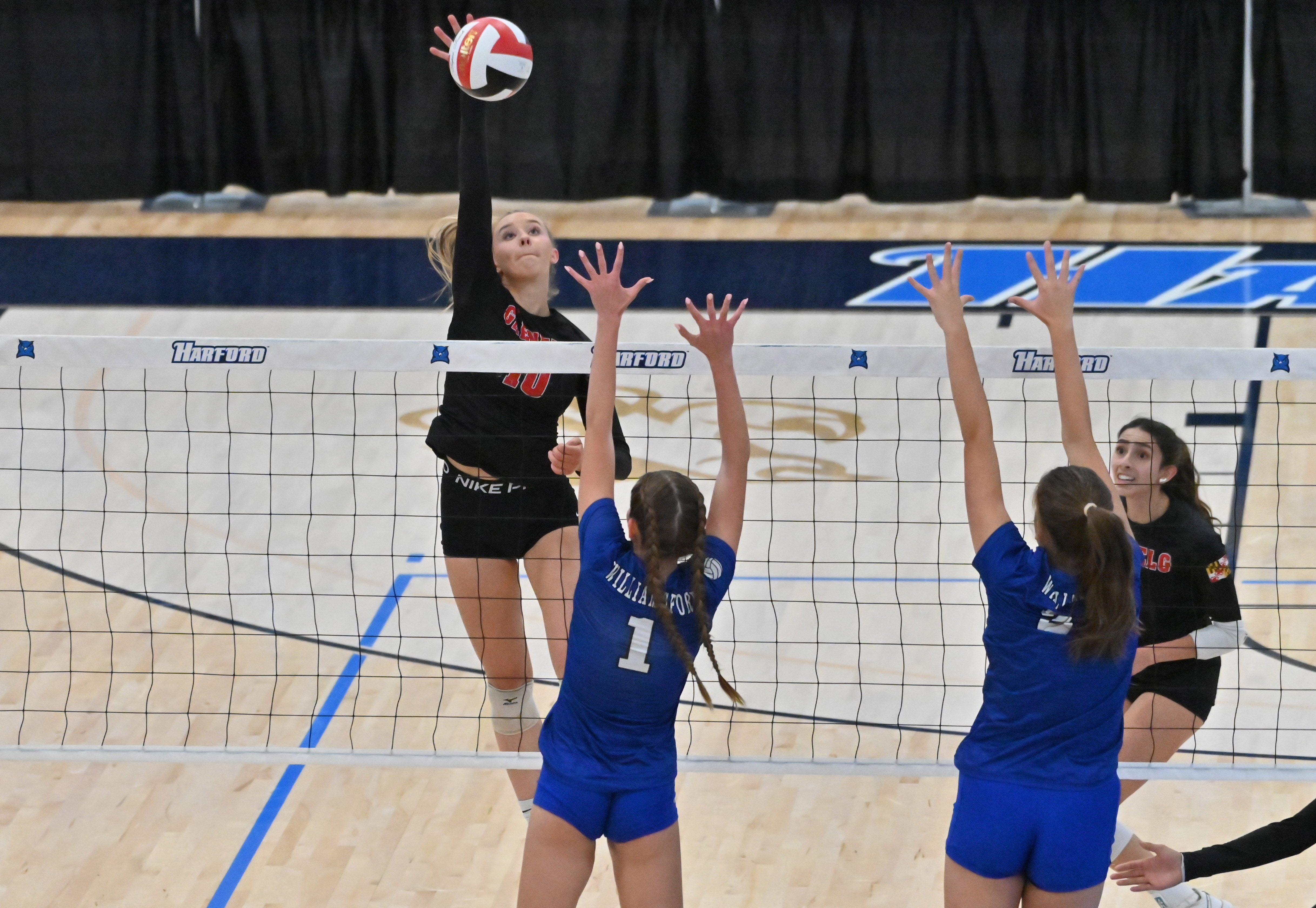 Glenelg's Avery Hubbard tries for a kill against Williamsport blockers during the Class 2A volleyball state championship at Harford Community College on Saturday. (Brian Krista/Staff)