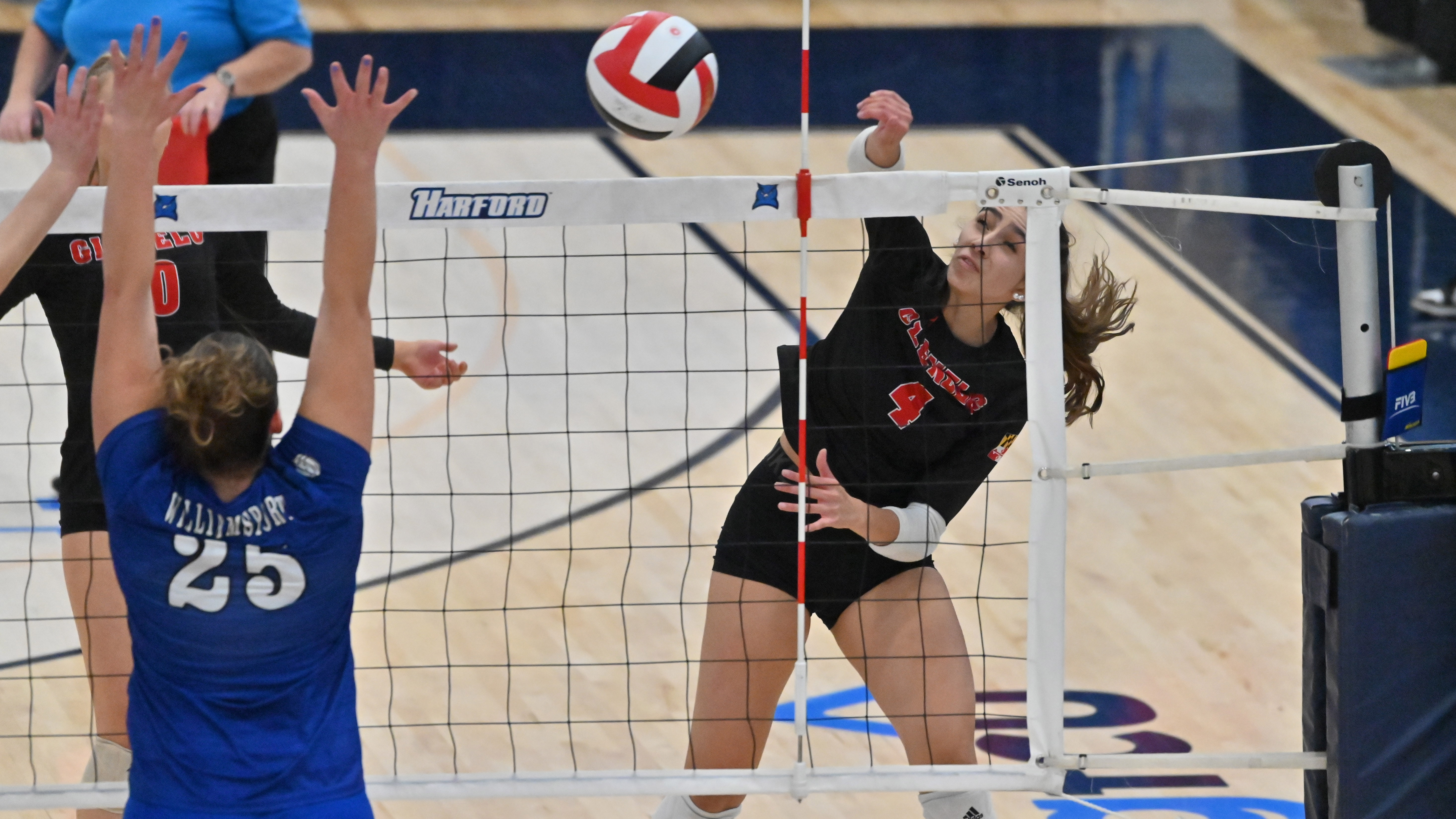 Glenelg's Isard Bernades tries for a kill against Williamsport blocker Hannah Small during the Class 2A volleyball state championship at Harford Community College on Saturday. (Brian Krista/Staff)