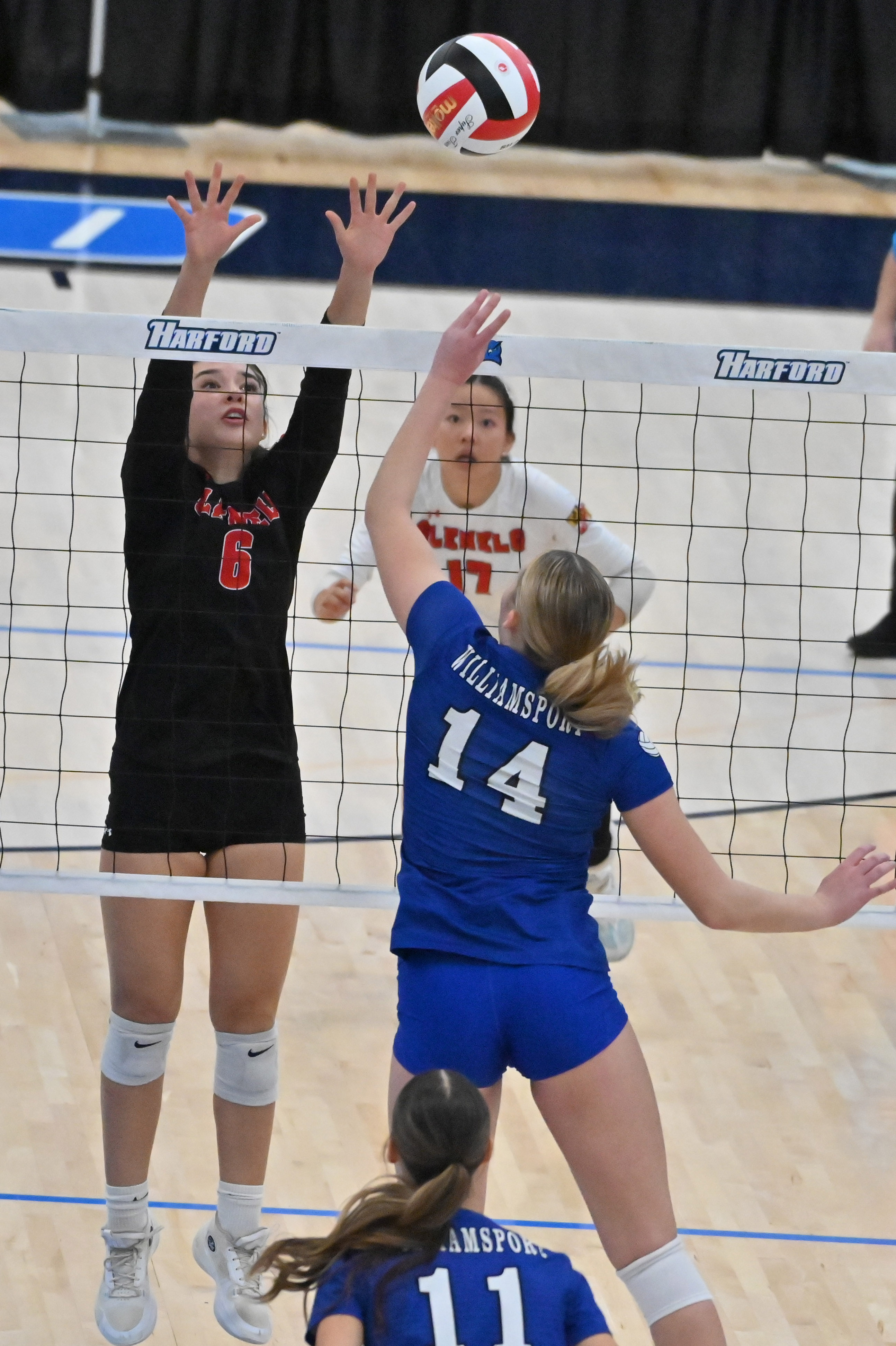 Glenelg's Lainey White tries to block a hit by Williamsport's Elliana Schwartz during the Class 2A volleyball state championship at Harford Community College on Saturday. (Brian Krista/Staff)