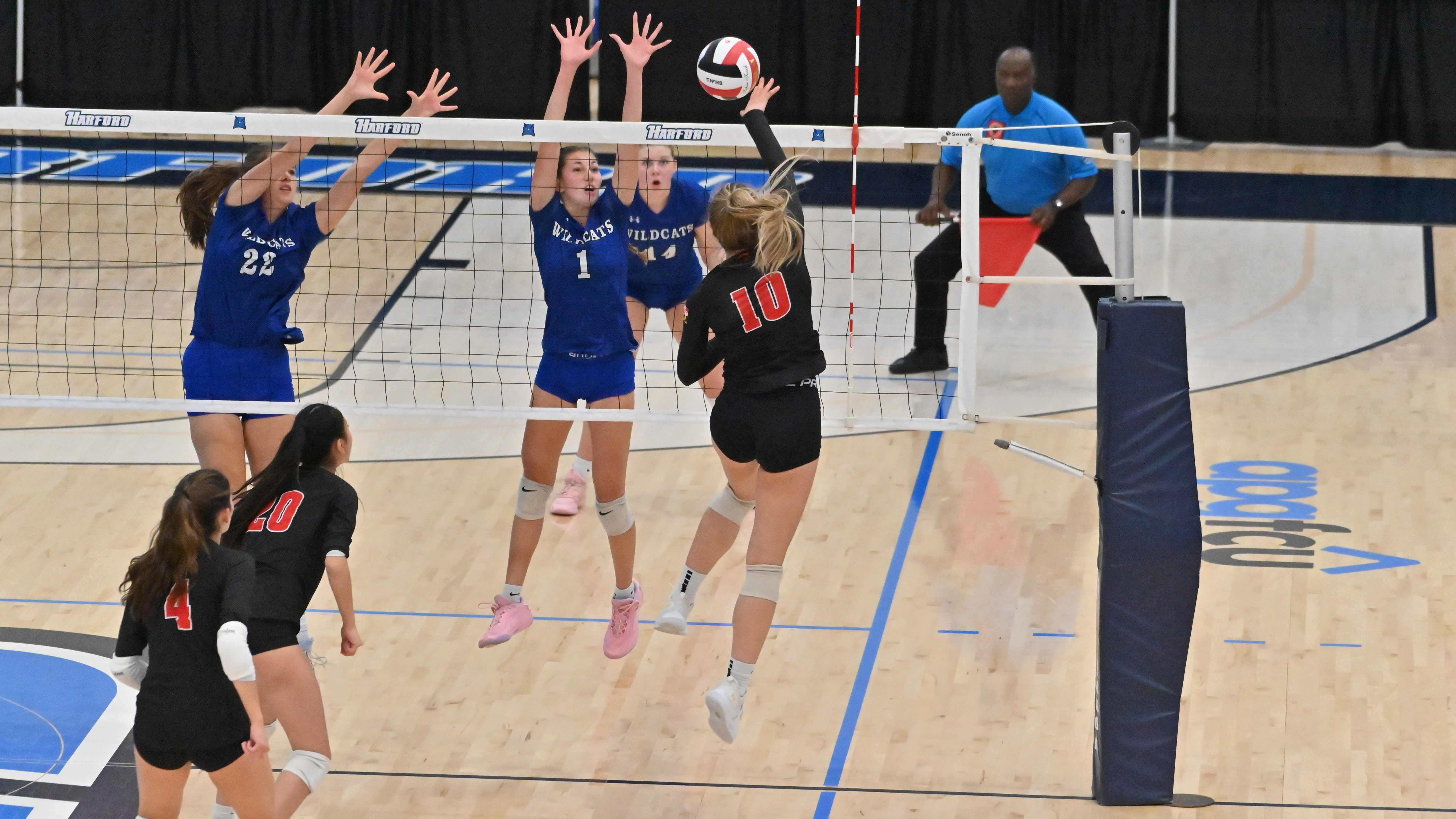 Glenelg's Avery Hubbard #10 tries to hit the ball over Williamsport blockers Skylar Norris and Abigail Paulson, left, during the Class 2A volleyball state championship at Harford Community College on Saturday. (Brian Krista/Staff)