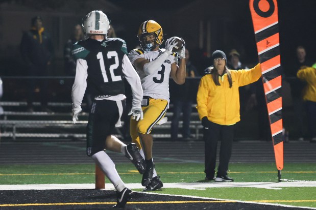 St. Laurence's Sean Rice (3) keeps his feet inbounds for a touchdown catch against Oak Lawn in the first round of the playoffs on Friday, Oct. 31, 2025, in Oak Lawn. (Gary Middendorf/for the Daily Southtown)