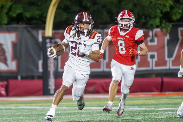 Brother Rice's Damari Thigpen (28) returns a punt against Marist during a non-conference game in Chicago on Friday, Sept. 5, 2025. (Troy Stolt for Daily Southtown)