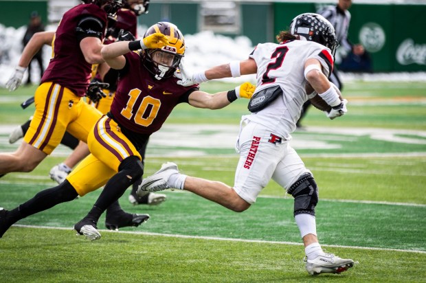 Pomona running back Luis Santana (2) slips a tackle by Windsor's Creede Hunt (10) during the 3A football state championship game between Windsor and Pomona at Canvas Stadium on the campus of Colorado State University in Fort Collins on Saturday, Dec. 6, 2025. (Brice Tucker/Staff Photographer)