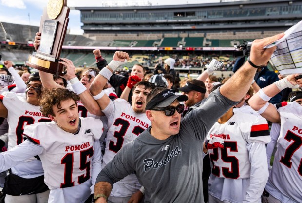 Pomona players and head coach Nathan Johnson celebrate after their win over Windsor in the 3A football state championship game at Canvas Stadium on the campus of Colorado State University in Fort Collins on Saturday, Dec. 6, 2025. (Brice Tucker/Staff Photographer)