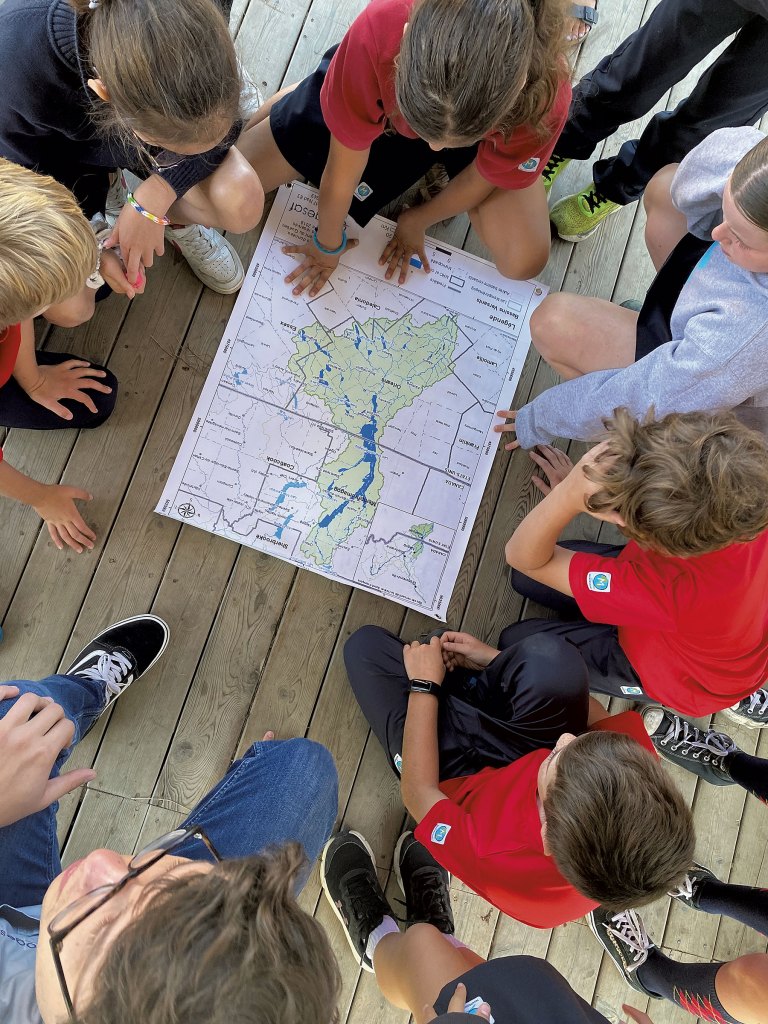 Magog Montessori School students exploring a Lake Memphremagog watershed map