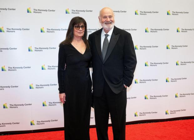 Rob Reiner and Michele Singer Reiner arrive on a red carpet.