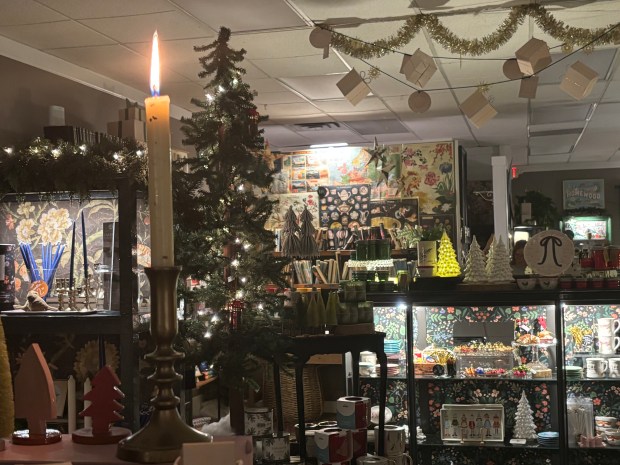 A candle burns in Loulou Belle, Lisa Komorowski's business, in downtown Homewood, Dec. 18, 2025. (Evy Lewis/Daily Southtown)