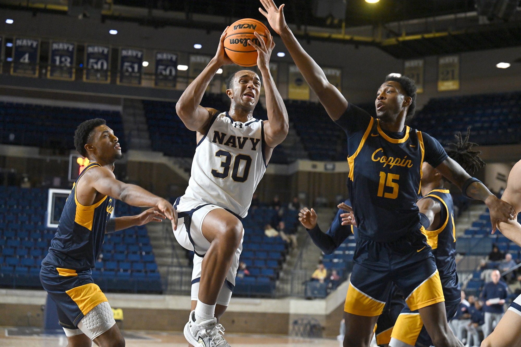 Dec. 19, 2025 Navyâs Mike Woods scores over Coppin State’s...