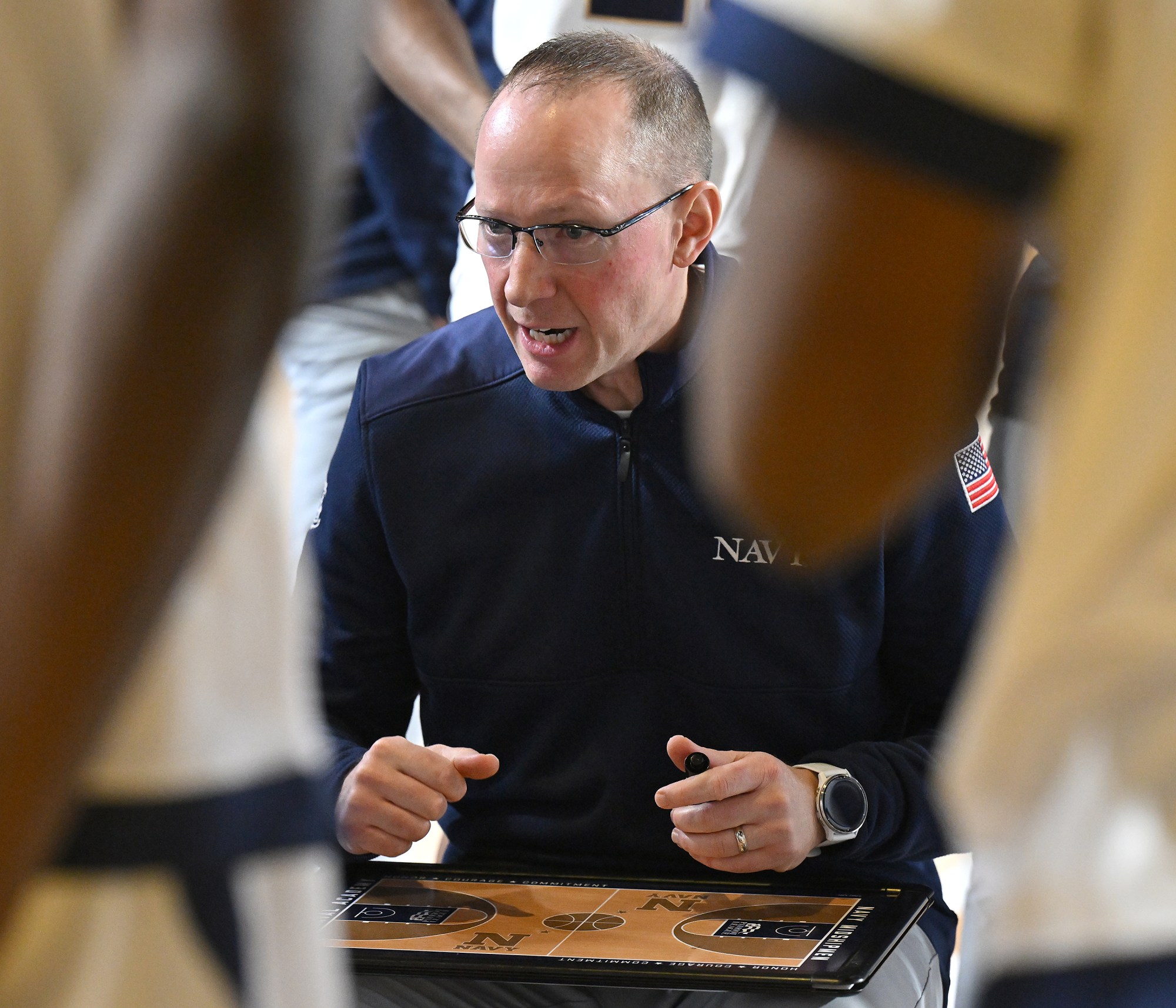 Dec. 19, 2025 Navy coach Joe Perry during a timeout...