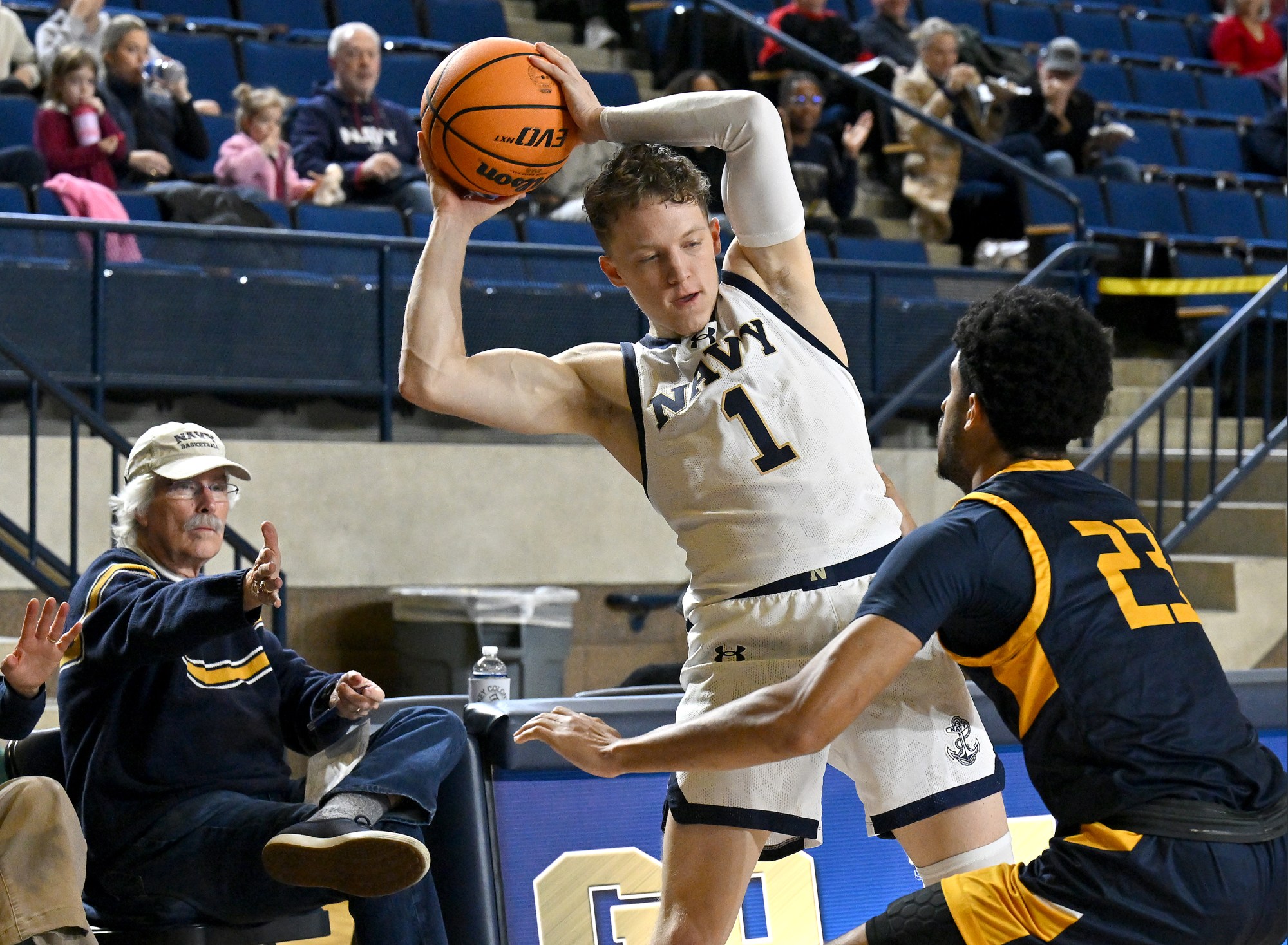 Dec. 19, 2025 Navyâs Austin Benigni works to keep the...