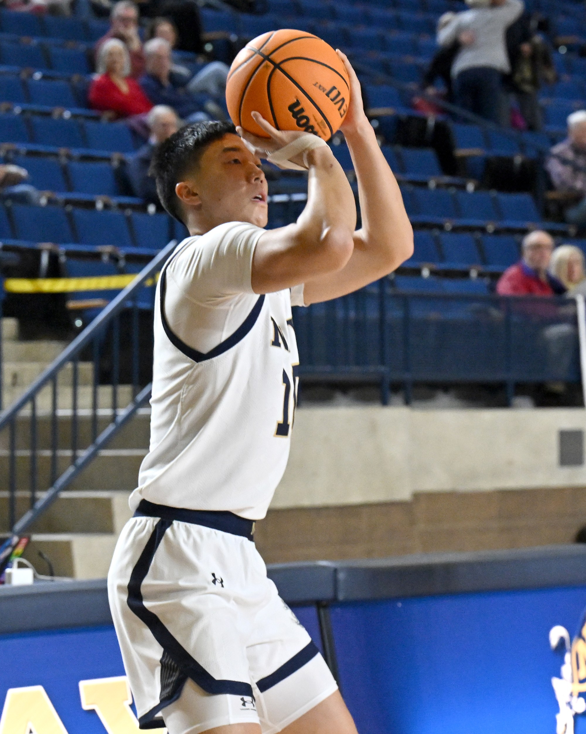 Dec. 19, 2025 Navyâs Jinwoo Kim attempts a three point...