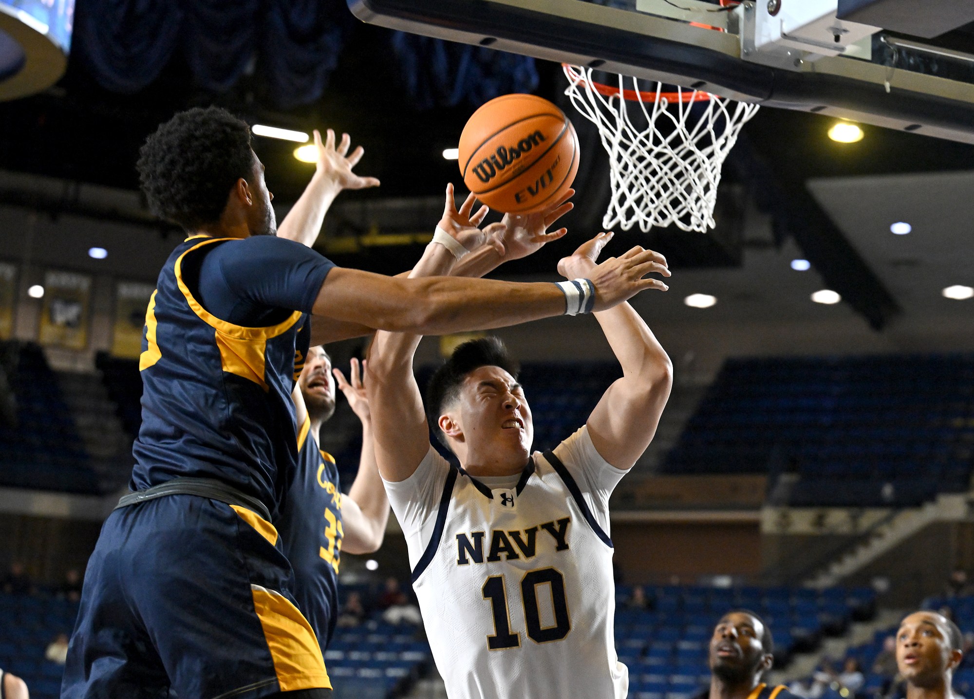 Dec. 19, 2025 Navyâs Jinwoo Kim is fouled by Coppin...