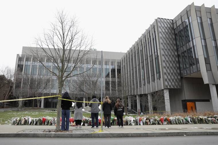 REUTERS/TAYLOR COESTER / DEC. 17
                                Community members bring flowers to a growing makeshift memorial outside the Barus & Holley building as the manhunt continues for the gunman, following a shooting at Brown University in Providence, Rhode Island.
