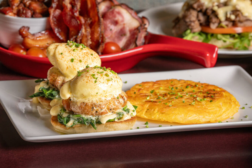 Crab cakes Benedict, front, and other dishes from The Kitchen Table, which opened in December 2 ...