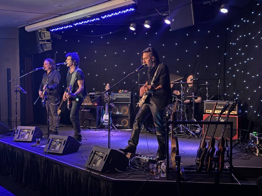 Phil Soussan, center, is shown with guitarists Zach Throne, left, Christian Brady, right, and d ...