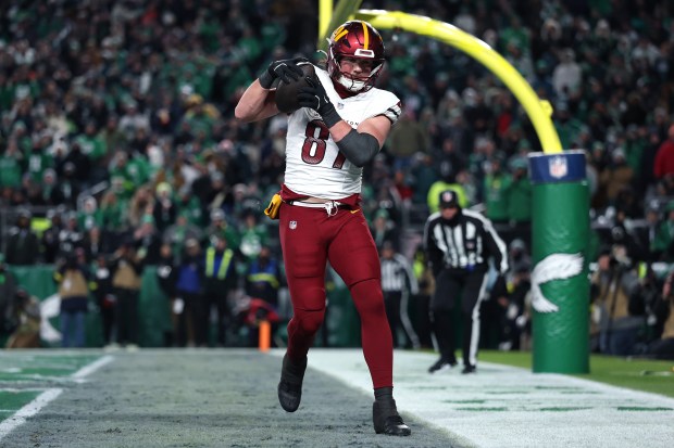 Washington Commanders tight end John Bates makes a game-tying touchdown catch against Philadelphia in the fourth quarter Sunday. (Emilee Chinn/Getty)