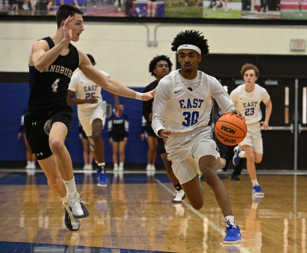 Lincoln-Way East's KaiJay Brown (30) works up court against Sandburg's William Hooks (4) during a SouthWest Suburban Conference game Tuesday, Jan. 13, 2026 in Frankfort, IL. (Steve Johnston/for the Daily Southtown)