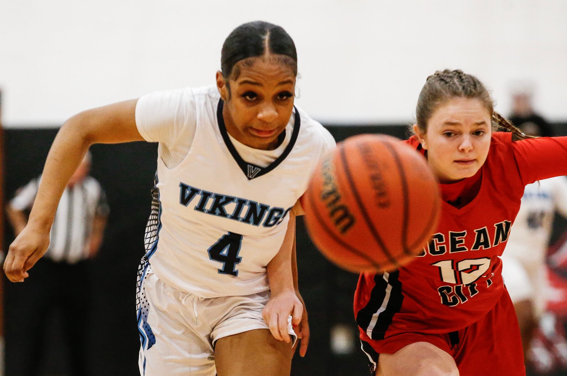 Demyah Townsend (4) of Atlantic City and Casey Adamson (12) of Ocean City battle for the loose ball during the girls basketball game between Ocean City and Atlantic City at Ocean City High School in Ocean City, NJ on 1/14/26.