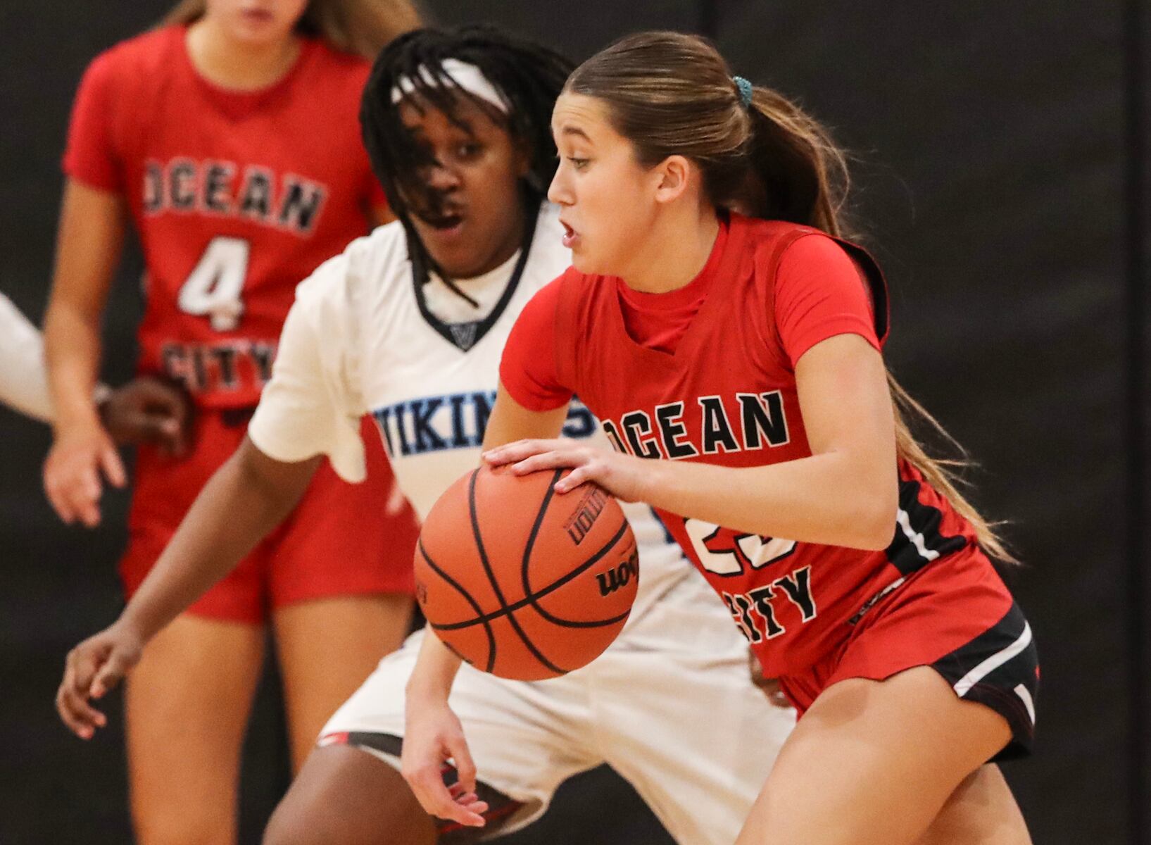 Kaia Chew (23) of Ocean City drives against Sage Demby (1) of Atlantic City during the girls basketball game between Ocean City and Atlantic City at Ocean City High School in Ocean City, NJ on 1/14/26.