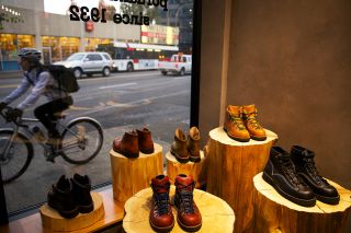 display of boots next to a storefront window