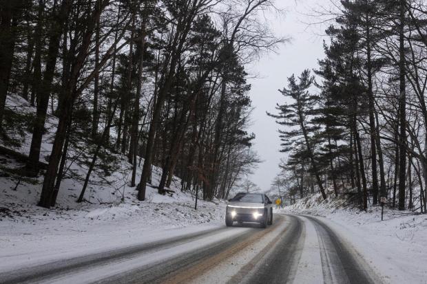 A Tesla Cyber truck is driven along North Scenic Drive through Muskegon State Park during a winter storm warning in Muskegon County, Mich. on Saturday, January 17, 2026. (Joel Bissell/Kalamazoo Gazette via AP)